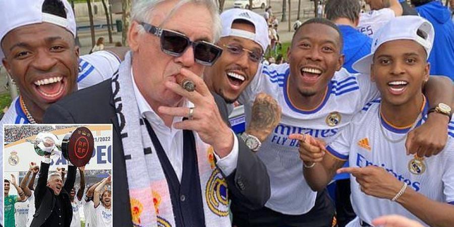 Cool Carlo Ancelotti enjoys a cigar in brilliant celebratory photo during Real Madrid's LaLiga title celebrations... after 62-year-old clinched his fifth league trophy in five different countries