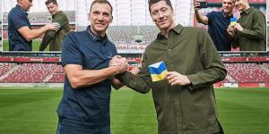 Robert Lewandowski vows to 'carry the colours of Ukraine to the World Cup' as Andriy Shevchenko presents the Poland captain with a blue and yellow captain's armband in meeting of goalscoring greats 