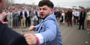 Brawl breaks out at Aintree as bloodied male racegoers throw punches at each in the stands after huge crowds enjoyed a day on the booze