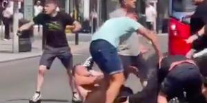 Man United and Man City fans brawl in the street before the FA Cup final, with shirtless man knocked out in the road, to the horror of passing shoppers