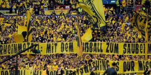 Borussia Dortmund supporters protest the club's new sponsorship deal with a German weapons manufacturer at the Champions League final as Gary Lineker voices his opposition