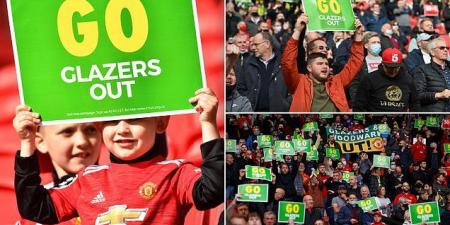 Manchester United fans wear green and gold scarves and hold anti-Glazer placards in protest at the club's owners as supporters return to Old Trafford for the first time in more than 400 days