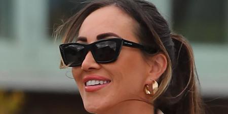 Lauryn Goodman can't keep the smile off her face as she steps out wearing a 'KW' necklace - amid claims England bosses will BLOCK her from being close to the team at the Euros to avoid distracting ex Kyle Walker