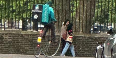 Just how late was this delivery?! Deliveroo driver seen transporting food to customers in west London on penny farthing bicycle first popularised in the 1880s