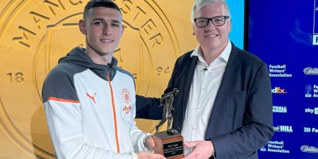 Phil Foden picks up his FWA Footballer of the Year trophy after spearheading Man City's Premier League title tilt... as frontrunners sit in pole position ahead of the season's final day