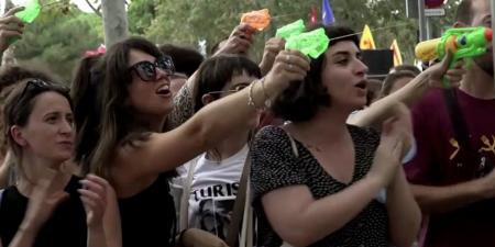 Angry mob of 'anti-tourism' protesters use water pistols to drench foreign visitors at restaurants in Barcelona - as thousands march on Catalan capital and call for tourists to 'go home'
