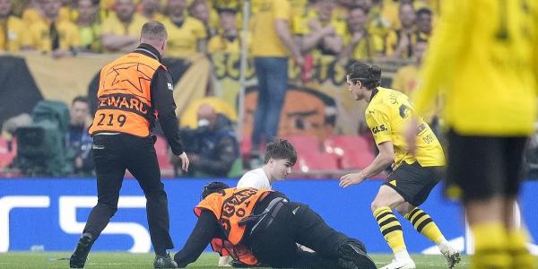 Champions League final disrupted by THREE pitch invaders as spectators get on the Wembley pitch in the opening minute... after FA spent £5million on 'ring of steel' operation to increase security
