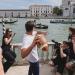 Tom Brady throws football at Venice's iconic Grand Canal to open E1 racing GP alongside glamorous boat designer - days on from team owner's hilarious Netflix roast