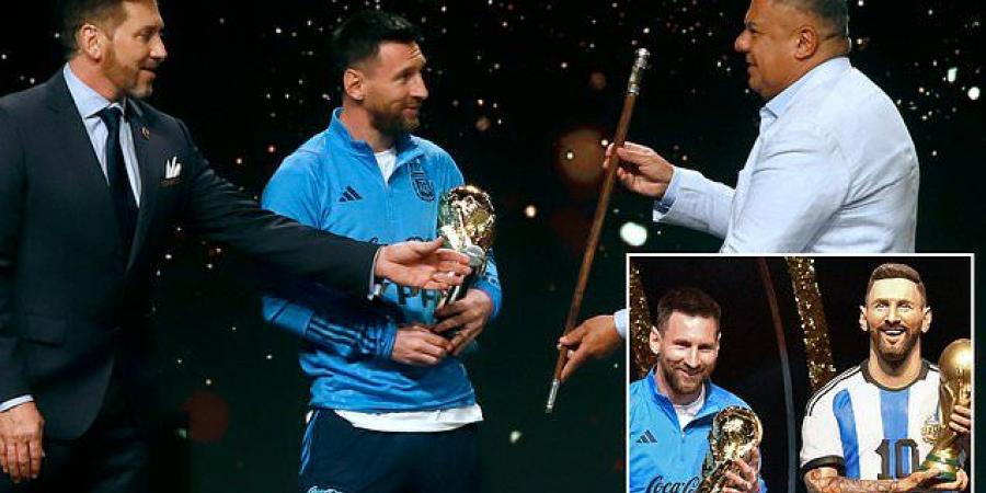 Lionel Messi is given ceremonial baton in bizarre CONMEBOL tribute which hands him 'leadership and command of world football'... at emotional ceremony where the Argentina legend's life-size statue is unveiled for the first time