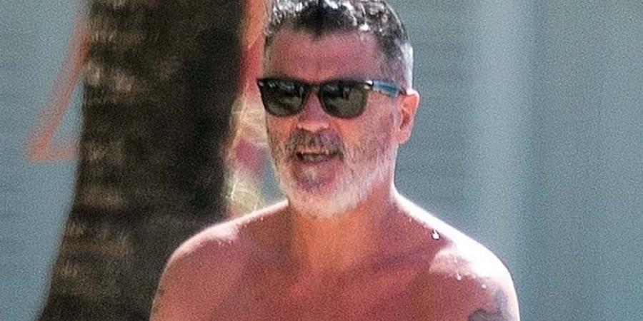 Roy Keane, 52, shows off his shirtless physique as he enjoys a beach day while on holiday in Barbados