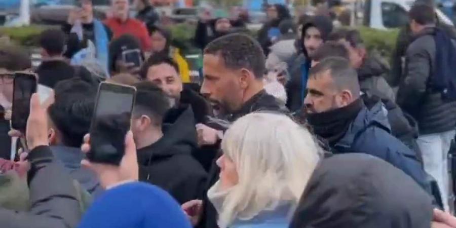 Man City fans are spotted taking selfies with Man United legend Rio Ferdinand prior to their quarter-final clash against Real Madrid... as rival supporters question the 'weird behaviour' outside the Etihad