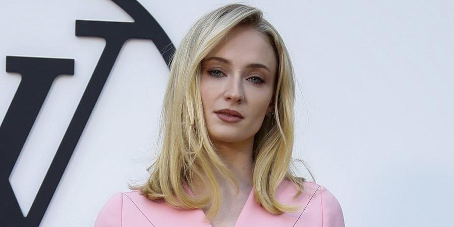 After her messy divorce from pop star Joe Jonas, it's looking more rosy for Sophie Turner - as she dons bubblegum pink Louis Vuitton trouser suit at Barcelona fashion show