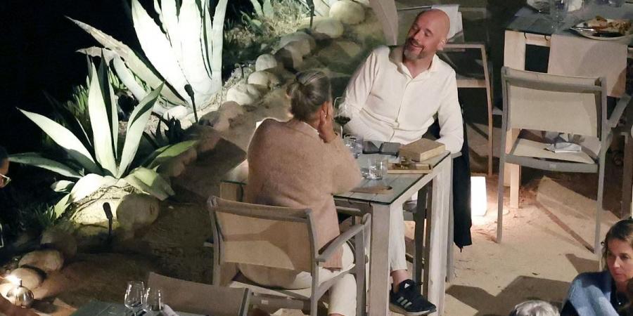 Erik ten Hag sips on red wine on holiday with his wife - and a subtle hint on his cap - as Man United opt to keep  the FA Cup-winning manager after INEOS' end-of-season review