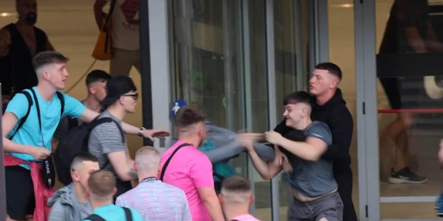 Shocking moment British holidaymakers brawl with each other in broad daylight outside Ibiza airport amid Spanish island's growing anger at antisocial tourists