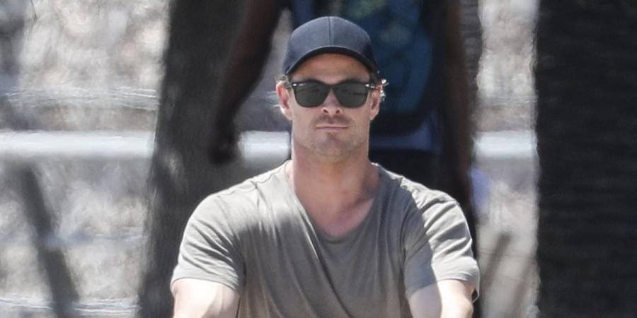 Chris Hemsworth enjoys a bike ride with his wife Elsa Pataky and their children during holiday to Barcelona