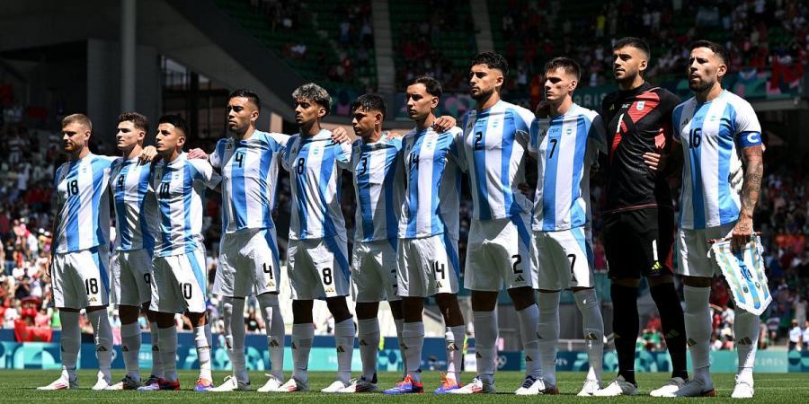 Ugly scenes mar Argentina's 2-1 defeat by Morocco at Olympics as fans boo national anthem and throw FLARES, cups and bottles at South American players amid Enzo Fernandez racism storm