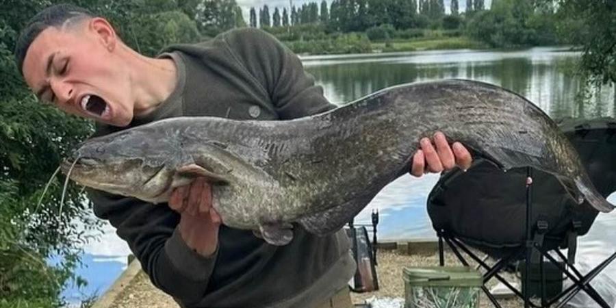 Phil Foden poses with a prize catch as the Manchester City star rounds off his pre-season holiday by landing a huge fish on a five-day family trip to a £14-a-day lake in Oxfordshire