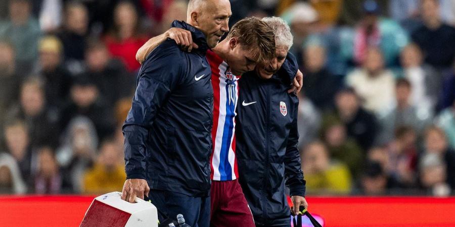 Martin Odegaard in tears - with his girlfriend crying in the stands - as he limps off in agony for Norway, just six days before Arsenal's north London derby - and boss admits it looks 'bad'